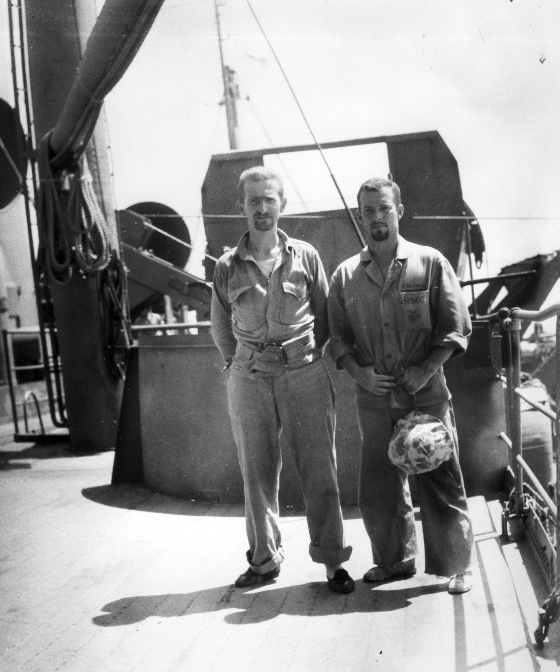 Matthews, on left, aboard the USS Biddle en route to Tarawa. (His companion, "Falwell," is a bit of a puzzle as that surname does not appear on muster rolls of the period.) Photograph by Norm Hatch. [Source]